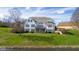 Large, bright waterfront home featuring a spacious lawn, deck, and manicured landscaping at 999 Box Turtle Ct, Columbus, IN 47201