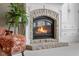 Detailed view of the stone fireplace with a burning fire at 999 Box Turtle Ct, Columbus, IN 47201