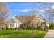 Inviting stone-front home with manicured lawn and mature trees at 999 Box Turtle Ct, Columbus, IN 47201