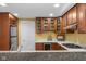 Modern kitchen showcasing wooden cabinets, stainless appliances, granite countertops and bar seating at 999 Box Turtle Ct, Columbus, IN 47201