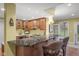 Modern kitchen with updated stainless appliances, wooden cabinetry, granite counters and bar seating at 999 Box Turtle Ct, Columbus, IN 47201
