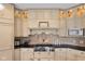 A chef's kitchen features cream cabinets, granite counters and backsplash plus a professional grade range at 999 Box Turtle Ct, Columbus, IN 47201
