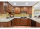 Modern kitchen featuring wooden cabinets, stainless appliances, and a clean countertop space at 999 Box Turtle Ct, Columbus, IN 47201