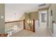 Second floor landing with hardwood railings and lots of natural light at 999 Box Turtle Ct, Columbus, IN 47201