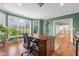 Bright home office offers a large desk, natural light, and scenic views of the surrounding landscape at 999 Box Turtle Ct, Columbus, IN 47201