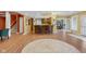 Spacious recreation room with hardwood floors, a bar area, and convenient access to the backyard at 999 Box Turtle Ct, Columbus, IN 47201