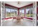 Sunroom with tile floor, red walls, floor to ceiling windows and green yard views at 999 Box Turtle Ct, Columbus, IN 47201