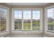 A bank of windows overlooking a tranquil pond surrounded by lush trees at 999 Box Turtle Ct, Columbus, IN 47201