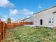 Spacious backyard featuring a wooden fence, a fire pit, and a well-maintained lawn at 10432 Dark Star Dr, Indianapolis, IN 46234