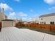 Expansive backyard with a large deck, wooden fence, and a view of neighboring homes at 10432 Dark Star Dr, Indianapolis, IN 46234