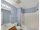 Bright bathroom featuring a single sink vanity, toilet, and shower-tub combination at 10432 Dark Star Dr, Indianapolis, IN 46234