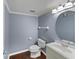 A well-lit bathroom featuring a modern vanity, toilet, and round mirror at 10432 Dark Star Dr, Indianapolis, IN 46234