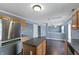 This kitchen features an island, stainless steel appliances, wood cabinets and an open layout at 10432 Dark Star Dr, Indianapolis, IN 46234