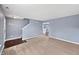 Spacious living room with plush carpeting, neutral walls, and a view into other rooms at 10432 Dark Star Dr, Indianapolis, IN 46234