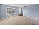 Inviting living room featuring plush carpeting, neutral walls, and abundant natural light at 10432 Dark Star Dr, Indianapolis, IN 46234