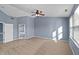 Large main bedroom with neutral carpet, ceiling fan, ensuite bath, and lots of light at 10432 Dark Star Dr, Indianapolis, IN 46234