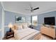 Cozy primary bedroom with soft lighting, a ceiling fan, and a serene ambiance at 10432 Dark Star Dr, Indianapolis, IN 46234