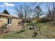Outdoor patio with a grill and fire pit in a spacious backyard, surrounded by trees and landscaping at 110 Jordan Ct, Martinsville, IN 46151