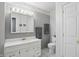 Bright bathroom with white vanity, neutral walls, and matching toilet at 110 Jordan Ct, Martinsville, IN 46151