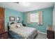 Cozy bedroom with a comfortable bed, matching wood furniture, and a bright window at 110 Jordan Ct, Martinsville, IN 46151
