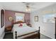 Bedroom with pink accent wall, white walls, wood furniture, and ceiling fan at 110 Jordan Ct, Martinsville, IN 46151