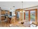 Eat-in kitchen featuring a center island, stainless appliances, wood cabinetry, and access to the backyard at 110 Jordan Ct, Martinsville, IN 46151
