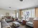 Comfortable living room featuring neutral tones, large windows, and a cozy seating arrangement with decor at 110 Jordan Ct, Martinsville, IN 46151