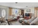 Inviting living room with cozy furniture, including a plush sofa and patterned armchairs and decor at 110 Jordan Ct, Martinsville, IN 46151