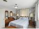 Bedroom featuring a queen bed, wood furniture, and wallpaper accent wall at 110 Jordan Ct, Martinsville, IN 46151