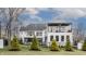 Spacious backyard with tall evergreens bordering a black metal fence at 11003 Holliday Farms Blvd, Zionsville, IN 46077
