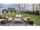 Backyard features a patio with comfortable seating around a glass-top coffee table at 11003 Holliday Farms Blvd, Zionsville, IN 46077