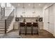 Stylish bar and entertaining area with a beautiful wine rack, barstool seating, and modern pendant lights at 11003 Holliday Farms Blvd, Zionsville, IN 46077
