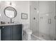 Modern bathroom with a dark blue vanity, white countertops, and glass-enclosed tiled shower at 11003 Holliday Farms Blvd, Zionsville, IN 46077