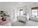 Brightly lit bedroom with a princess canopy bed, a white dresser, and a desk area at 11003 Holliday Farms Blvd, Zionsville, IN 46077