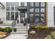 Inviting front entrance with landscaped flower beds leading to a modern door and gray exterior accents at 11003 Holliday Farms Blvd, Zionsville, IN 46077
