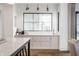Bright and airy kitchen with bar, custom cabinets and views of the home's living spaces at 11003 Holliday Farms Blvd, Zionsville, IN 46077