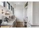 Bright kitchen featuring modern appliances, gray countertops, custom cabinetry, and ample natural light from black trimmed windows at 11003 Holliday Farms Blvd, Zionsville, IN 46077