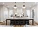 Gourmet kitchen boasts a large island with bar seating, custom cabinets, and modern pendant lighting at 11003 Holliday Farms Blvd, Zionsville, IN 46077