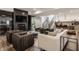 Inviting living room with a fireplace, TV, lots of seating, bar, and stairs to the second level at 11003 Holliday Farms Blvd, Zionsville, IN 46077