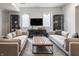 Comfortable living room with two sofas and a centered cocktail ottoman illuminated by natural light at 11003 Holliday Farms Blvd, Zionsville, IN 46077