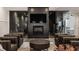 Modern living room with a fireplace, large screen TV, and stylish seating overlooking the workout room at 11003 Holliday Farms Blvd, Zionsville, IN 46077