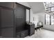 Mudroom featuring custom black lockers, built-in bench seating, herringbone floors, and a large window for natural light at 11003 Holliday Farms Blvd, Zionsville, IN 46077