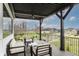 Relaxing covered patio with modern furniture and an incredible view of the neighborhood and green space at 11003 Holliday Farms Blvd, Zionsville, IN 46077