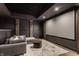 Home theater with a large screen, comfortable seating, and ambient lighting for an immersive viewing experience at 11003 Holliday Farms Blvd, Zionsville, IN 46077