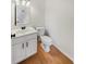Bathroom with wooden floors, white vanity, mirror and toilet, offering a functional space at 11063 Deer Valley Dr, Indianapolis, IN 46229