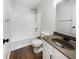 Bathroom featuring a shower-tub combo, modern vanity, and new fixtures with hardwood flooring at 11063 Deer Valley Dr, Indianapolis, IN 46229