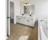 Bathroom featuring double sink vanity, soaking tub, and tile flooring, offering a spa-like experience at 11063 Deer Valley Dr, Indianapolis, IN 46229