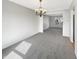 Spacious dining room with gray carpet and modern chandelier offers a welcoming atmosphere at 11063 Deer Valley Dr, Indianapolis, IN 46229