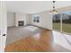 Bright living room featuring a fireplace, large windows, and hardwood flooring transitioning to carpet at 11063 Deer Valley Dr, Indianapolis, IN 46229