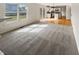 Comfortable living room with gray carpet and lots of natural light from sliding glass doors at 11063 Deer Valley Dr, Indianapolis, IN 46229